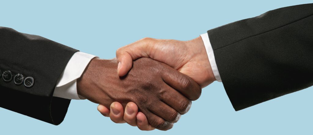 handshake of coach and client after signing an coaching agreement